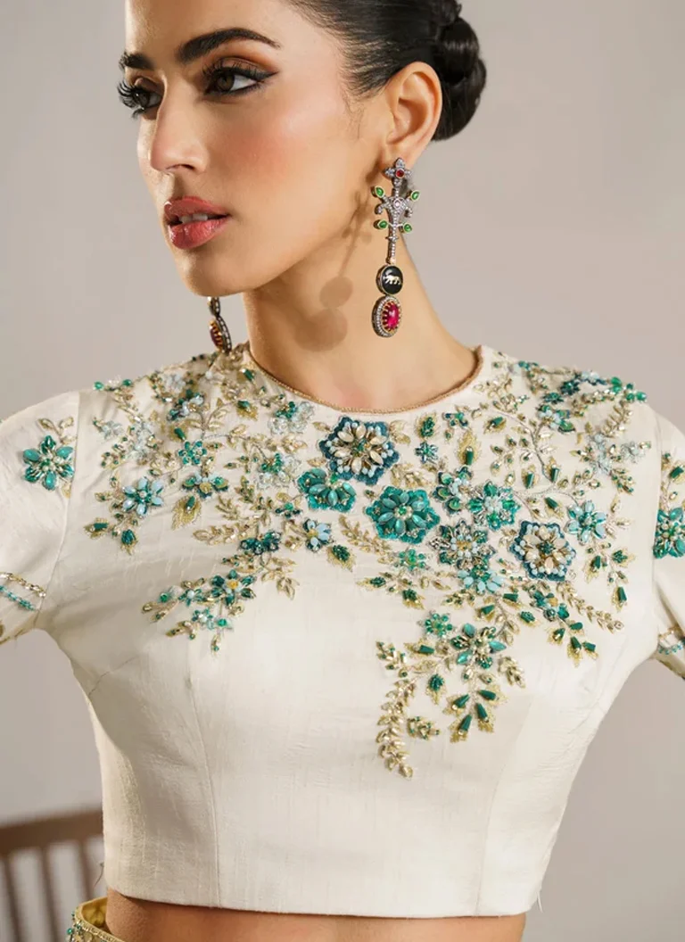 White embroidered saree with matching Korean raw silk blouse featuring hand embellishments and intricate embroidery
