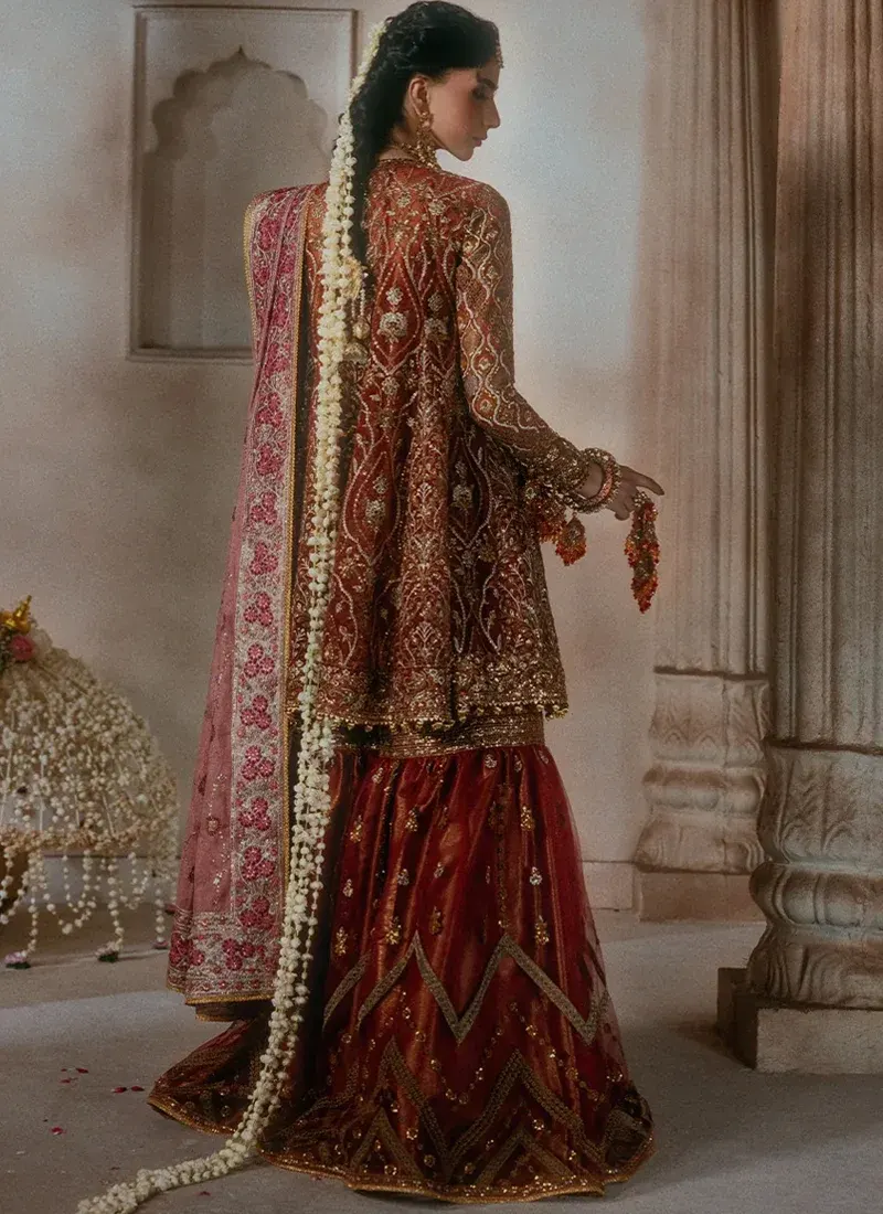 Dark green medium silk salwar kameez for wedding guests with hand embroidery and tassel detailing
