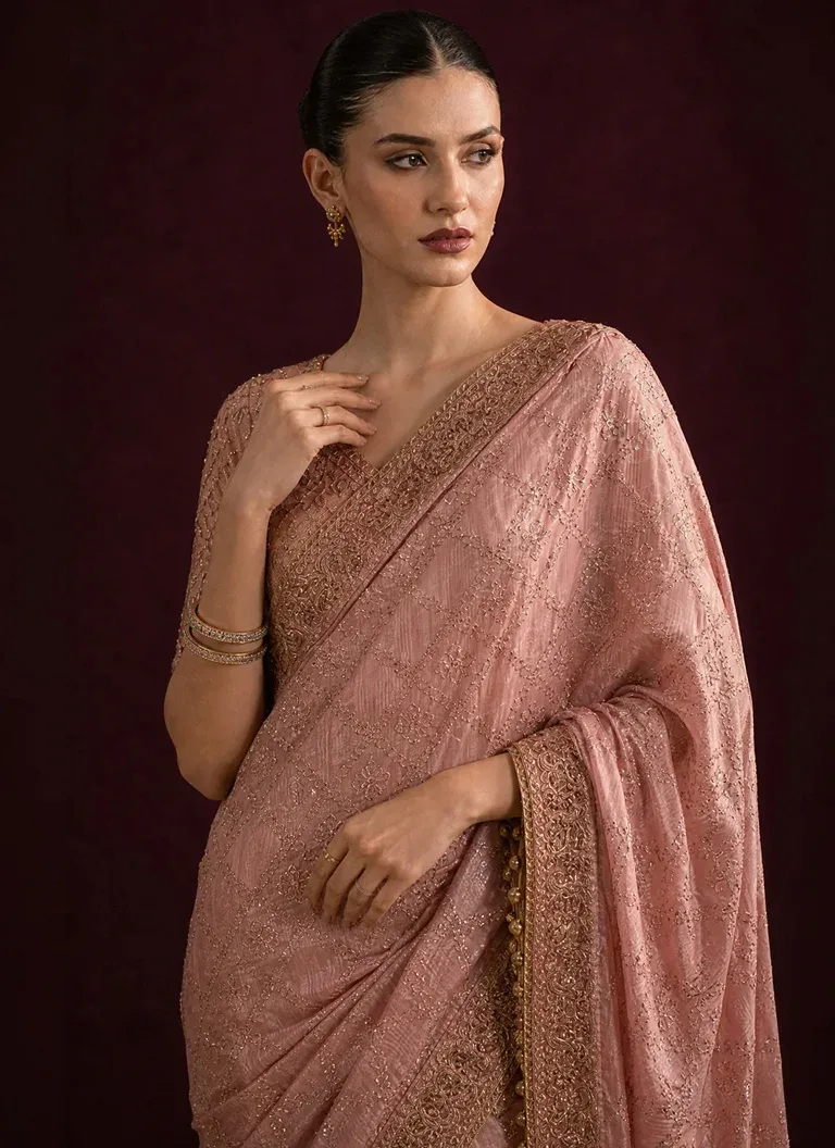Pink colour saree blouse for wedding guests featuring elegant embroidery, patchwork and crystal tassel embellishments