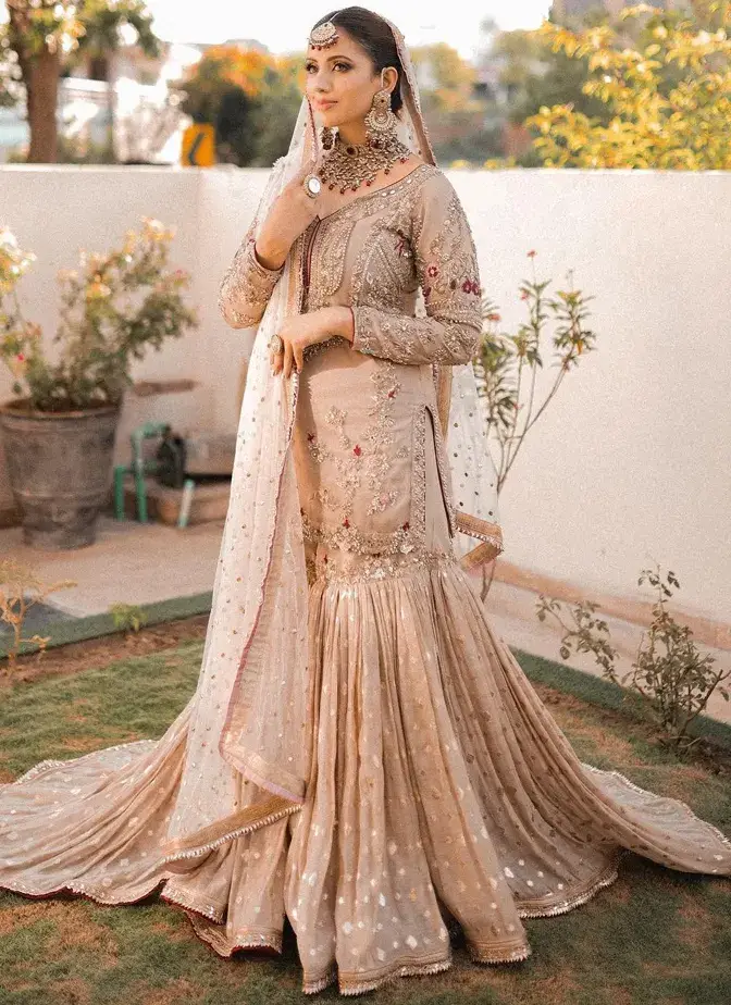Light brown bridal gharara with tissue silk shirt, 14-kali Brocia Farshi gharara, organza dupatta and ivory-gold embroidery