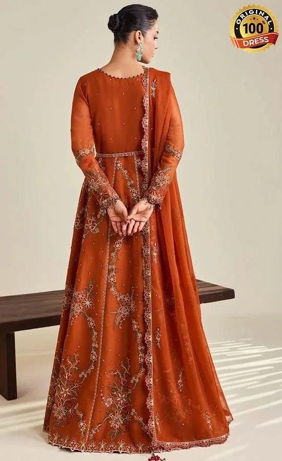 Embroidered orange Anarkali suit for wedding guests with traditional detailing and tassels