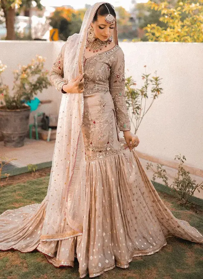 Light brown bridal gharara with tissue silk shirt, 14-kali Brocia Farshi gharara, organza dupatta and ivory-gold embroidery