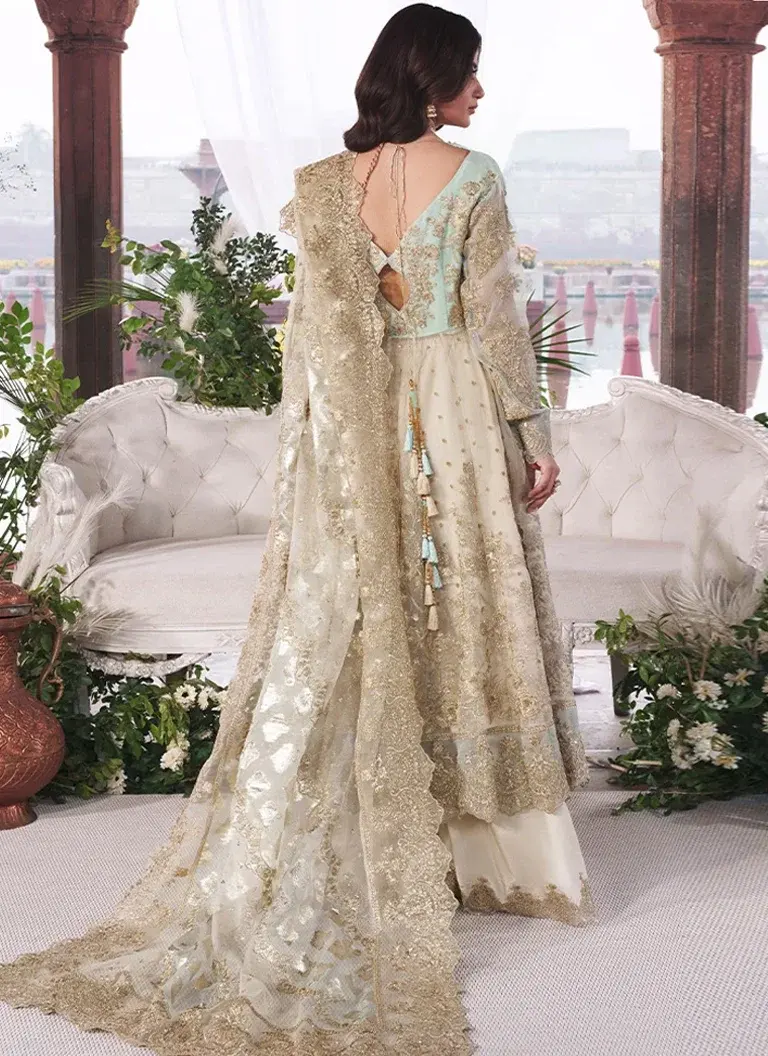 Green embroidered maxi dress for Pakistani wedding guests featuring detailed hand embroidery and tassel work