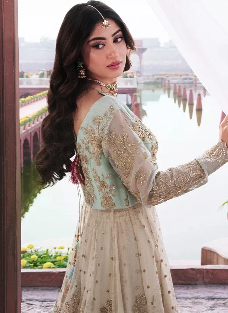 Pakistani green maxi wedding guest dress crafted in embroidered fabric with elegant traditional embellishments