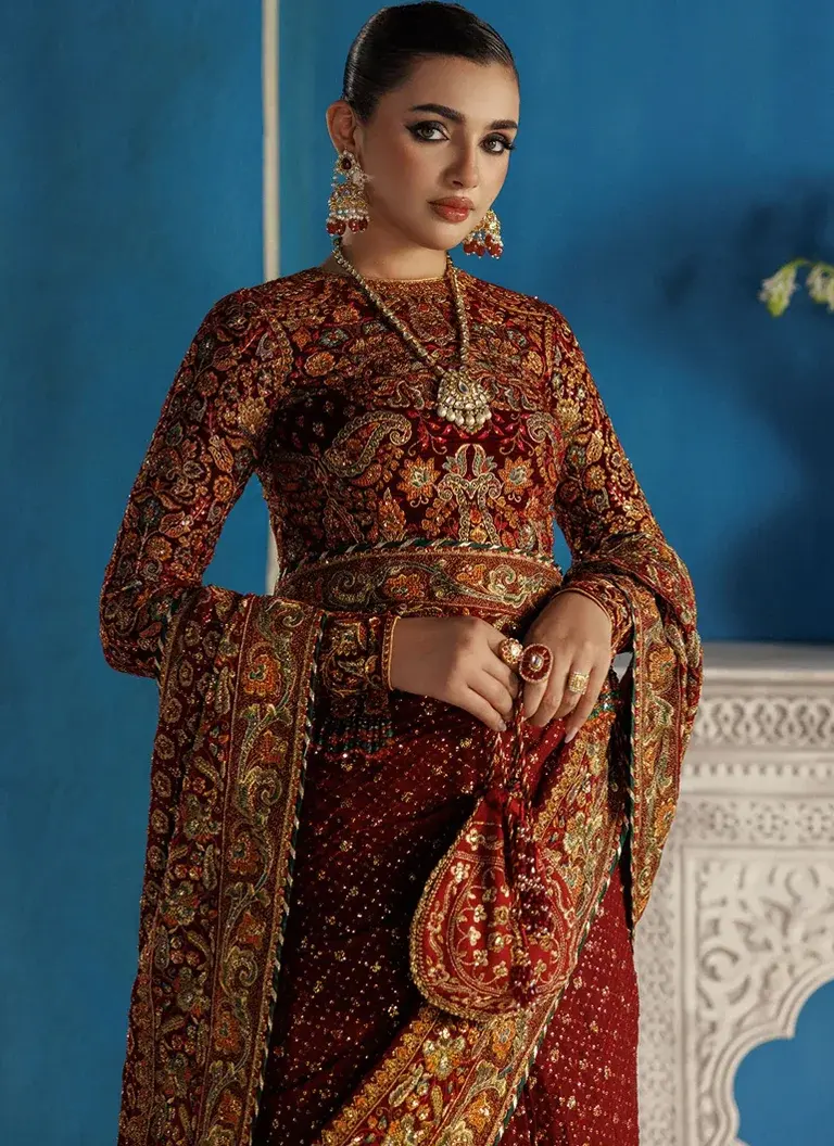 Burgundy chiffon saree with embroidered velvet blouse, organza saree border and decorative shuttle lace for wedding occasions