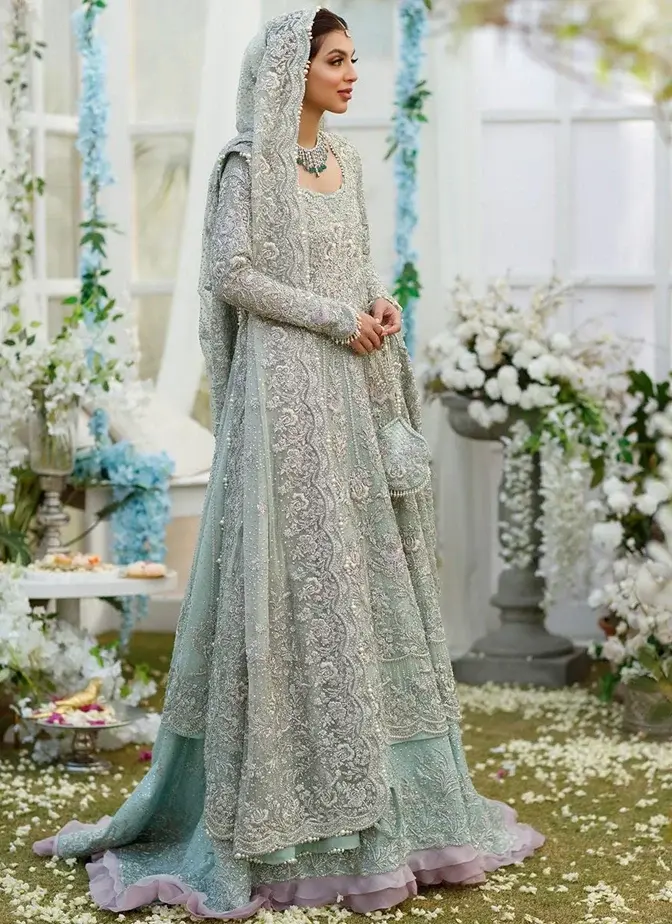 Aqua bridal outfit with ankle-length frock, tissue-silk lehenga, full sleeves and sweetheart neckline.