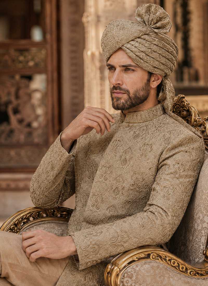 Close view of beige sherwani embroidery with a matching traditional turban