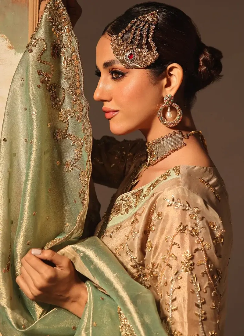 Champagne gold bridal Angrakha styled with flapper trousers and a contrasting mint green dupatta
