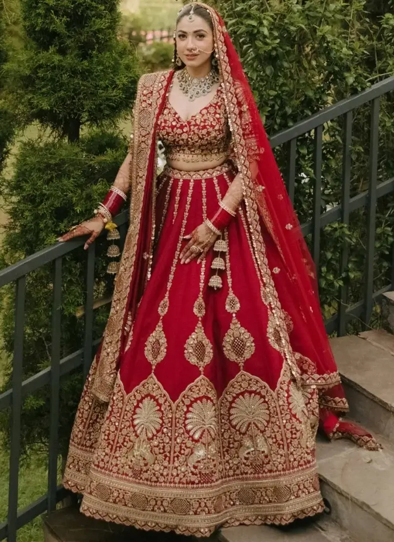 Deep Ruby Red Indian Bridal Lehenga Choli Deep ruby red bridal lehenga choli with a sweetheart blouse, pendant embroidery and antique-gold arch border