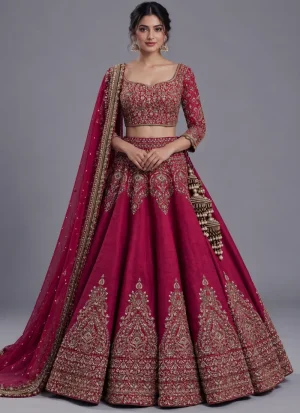 Burgundy bridal lehenga choli with antique-gold embroidery, arched hip motifs and a banded hem