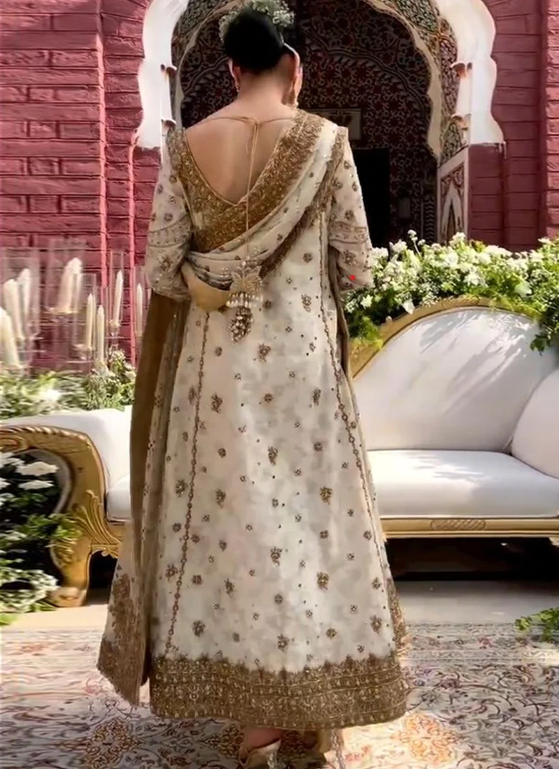 Ivory salwar kameez with boat neckline, deep round back, full sleeves and concealed zip fastening