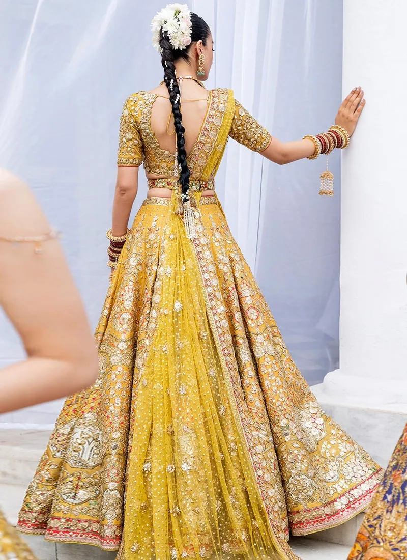 Mustard-yellow Mehndi lehenga with 14-kali flare, attached cancan and embellished waist belt
