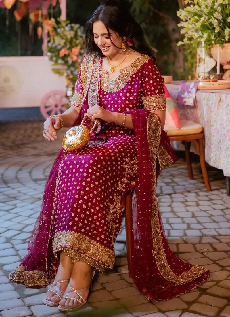Plum formal dress with gold zardozi, dabka and mirror work around the notched U-neck, sleeve edges and hem