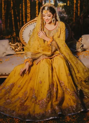Yellow Mehndi dress for bride with heavy hand embellishment and traditional bridal detailing