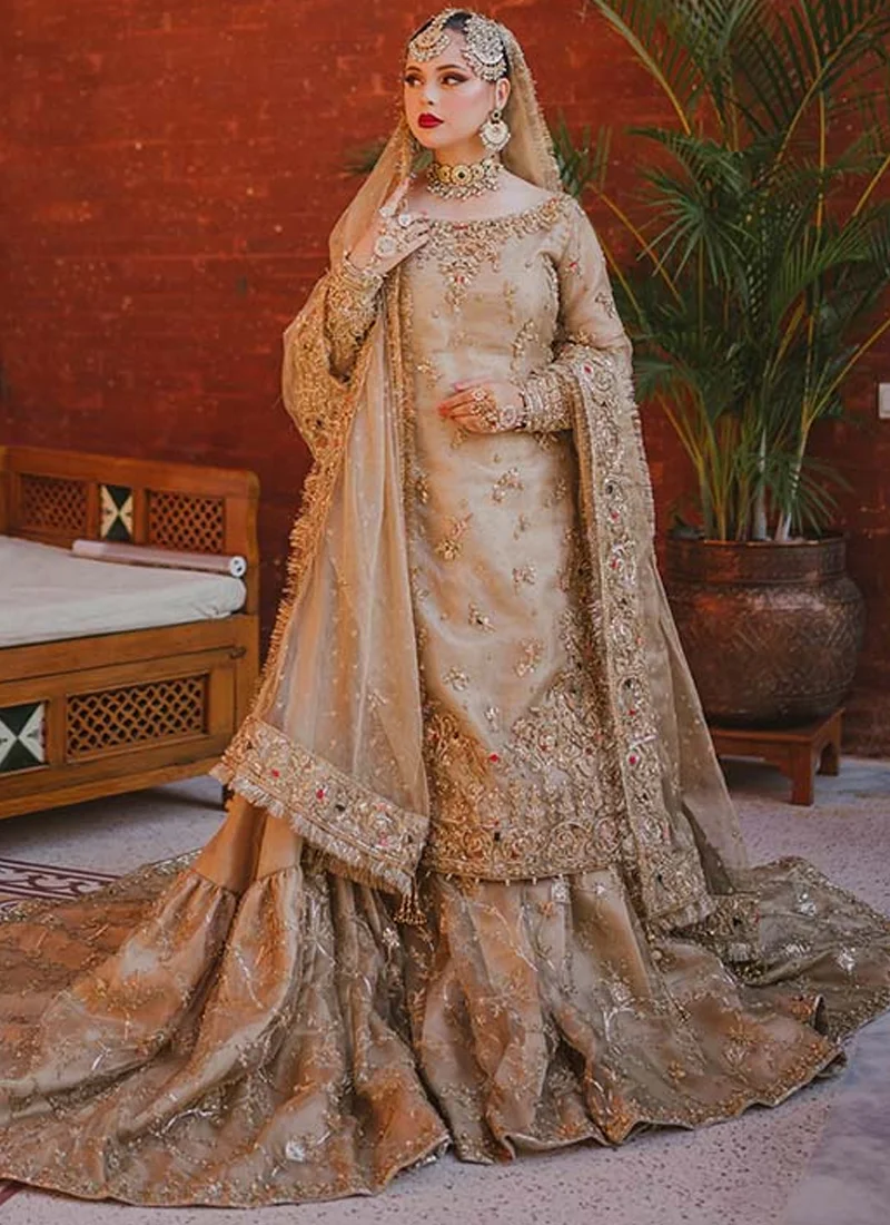 Champagne Nikkah Farshi Gharara with Long Embroidered Train Champagne gold farshi gharara front view showing floral embroidery and a wide flared bridal train