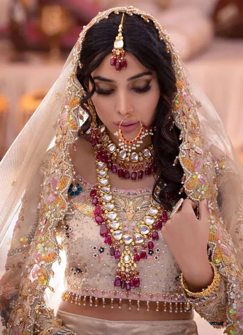 Champagne Walima lehenga choli, rear view showing a keyhole tie-back blouse and embroidered skirt border.