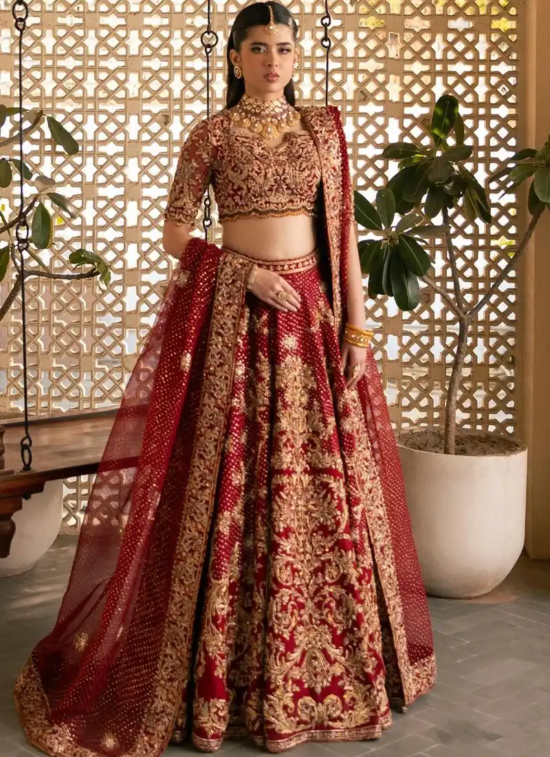 Deep Red Walima Lehenga Choli with Tasselled Dori Back Deep red lehenga choli back close-up showing gold floral embroidery, scalloped blouse hem and tasselled dori