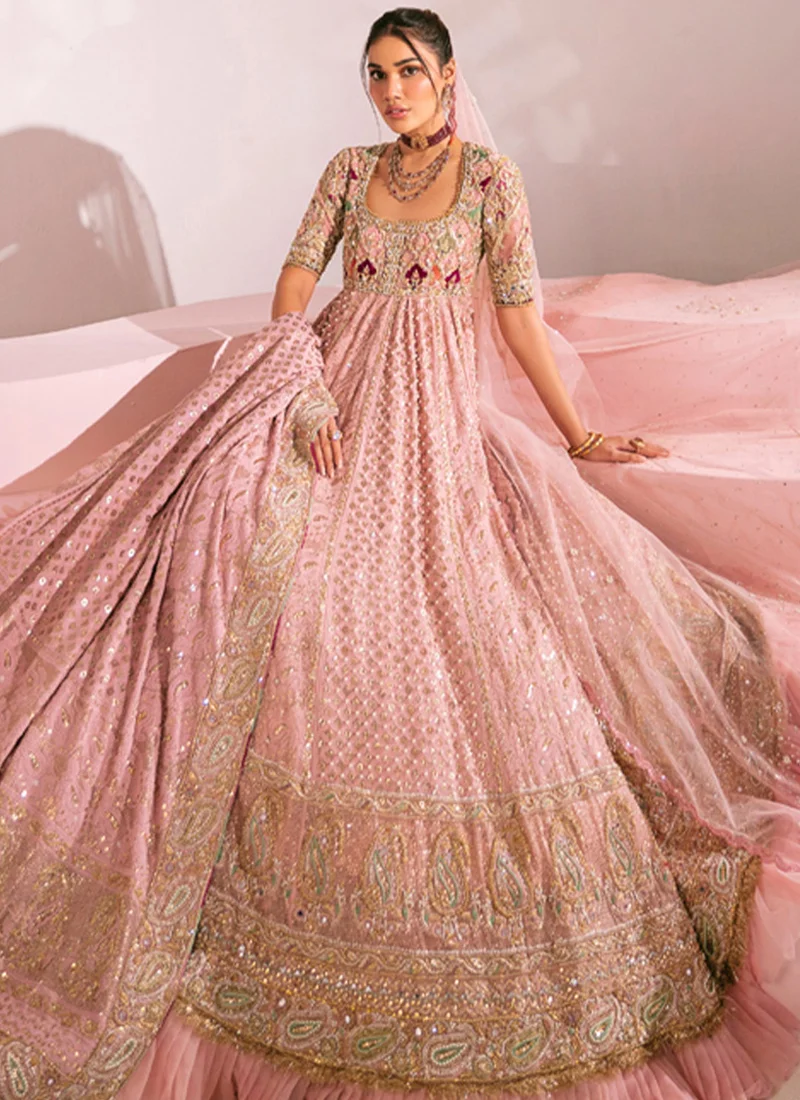 Dusty pink pishwas bodice close-up with a square neckline, gold mirrorwork and raised floral motifs.