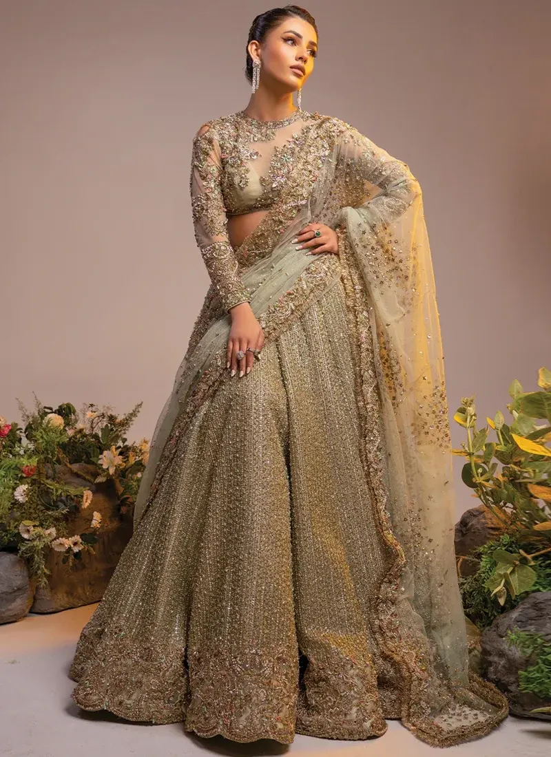 Gold Walima Lehenga Choli with Kiran-Lace Dupatta Border Gold walima lehenga choli front full-length view with sage dupatta and embroidered floral hem