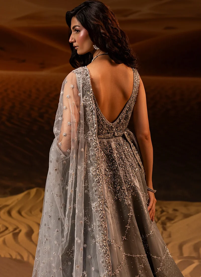 Gray bridal gown, full front view with embellished sleeveless bodice, flared lattice skirt and trailing veil