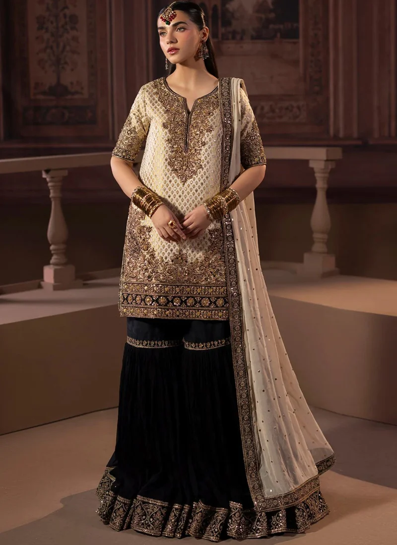 Ivory and black gharara suit, full back view, showing gold-printed shirt and wide embroidered black flounces