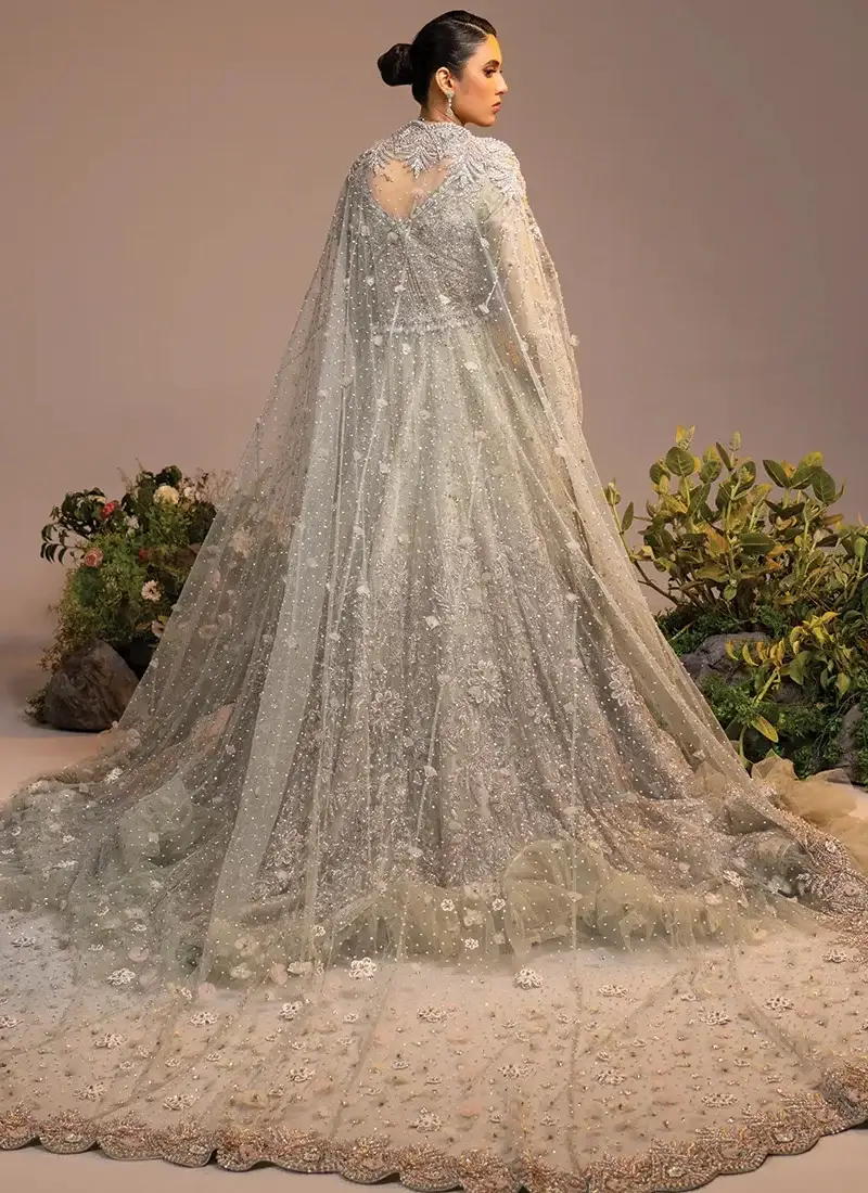 Ivory bridal gown three-quarter front view with silver floral embroidery and scalloped dupatta borders.