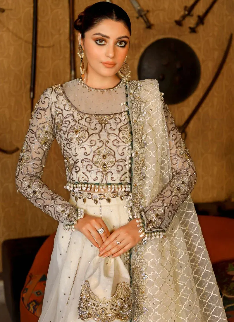 Ivory Walima lehenga choli side view with scalloped metallic hem, pleated frill and flowing patterned dupatta