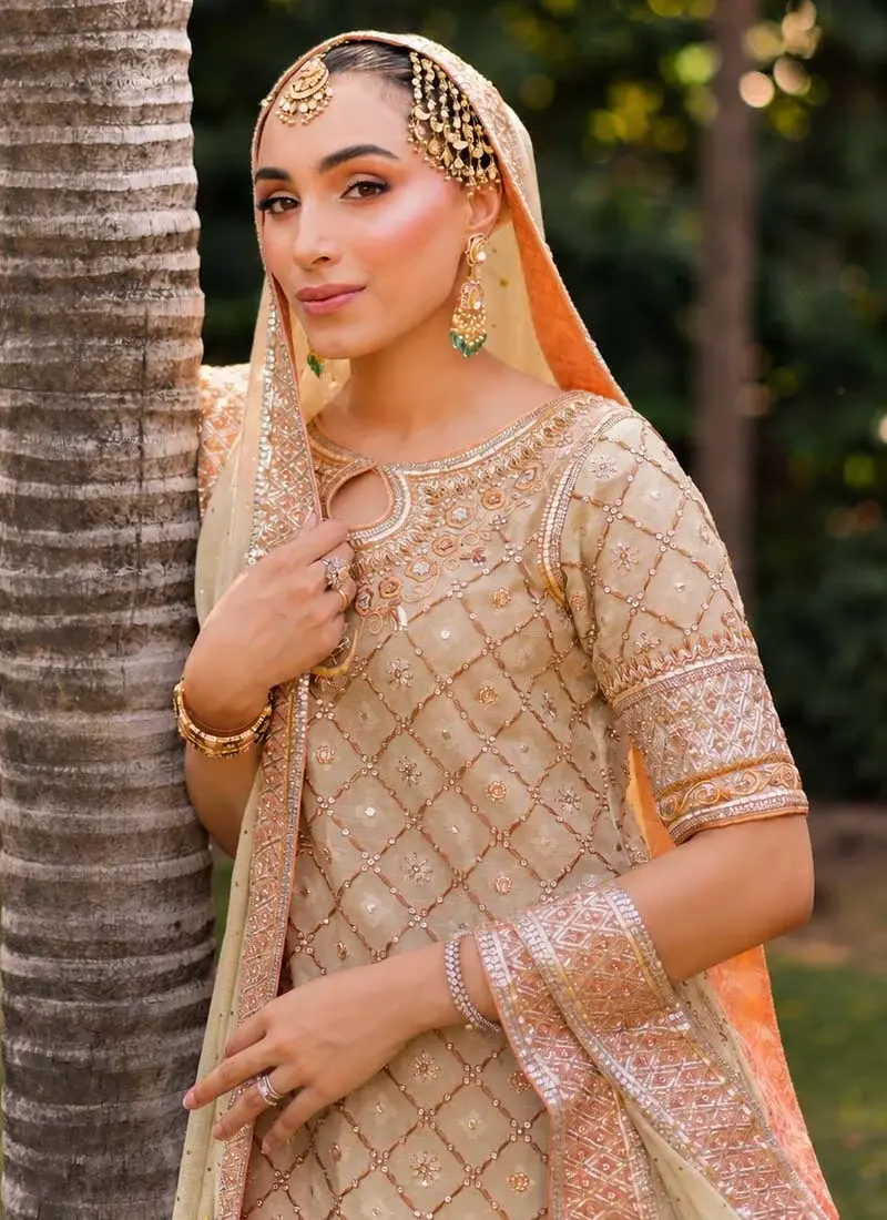 Ivory Wedding Guest Long Shirt Trousers Suit with Floral Diamond Jaal Ivory sage formal long shirt suit seated full view with narrow trousers and a long peach-bordered dupatta