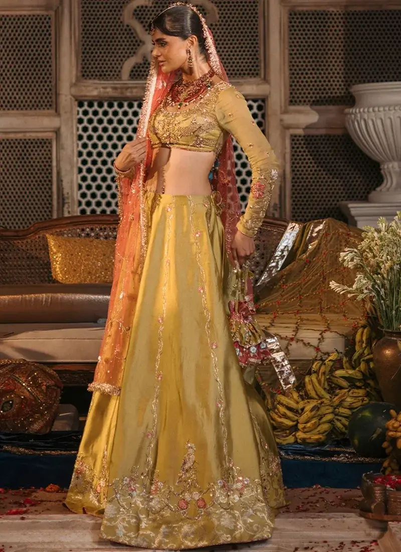 Mustard lehenga choli back view showing deep rounded tie-back blouse and coral dupatta with gold edging