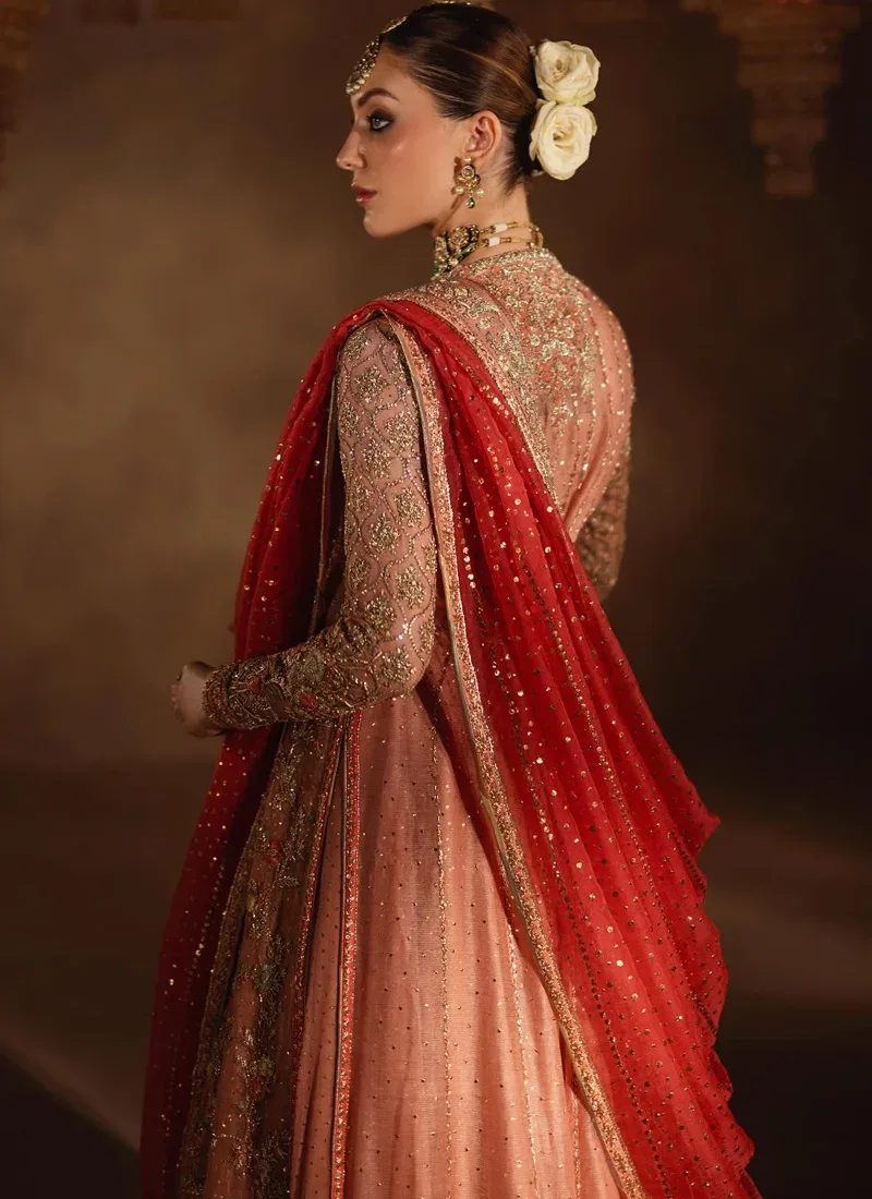 Dusty peach bridal angrakha back view with gold floral embroidery and a coral dupatta over the shoulder.