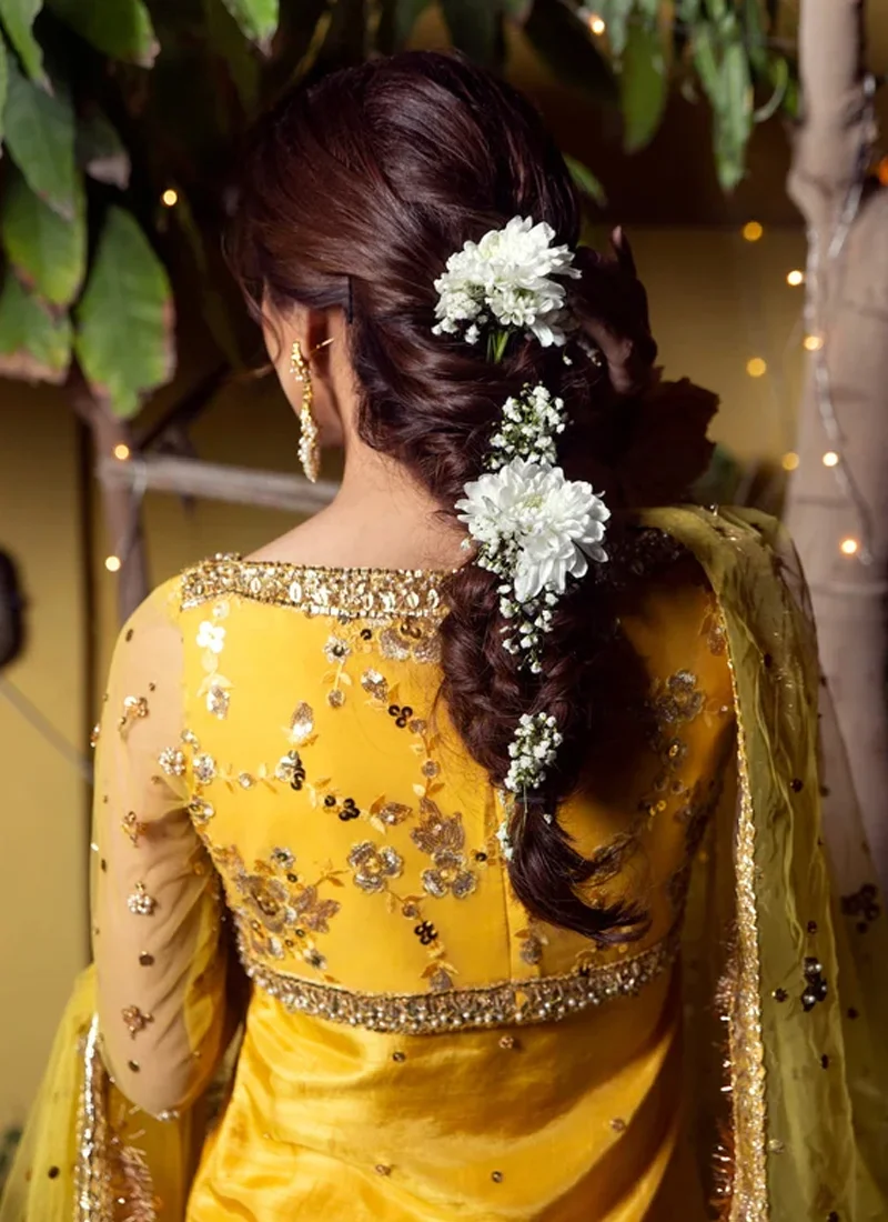 Yellow mehndi gharara suit front close-up with floral embroidered koti and gold-trimmed round neckline