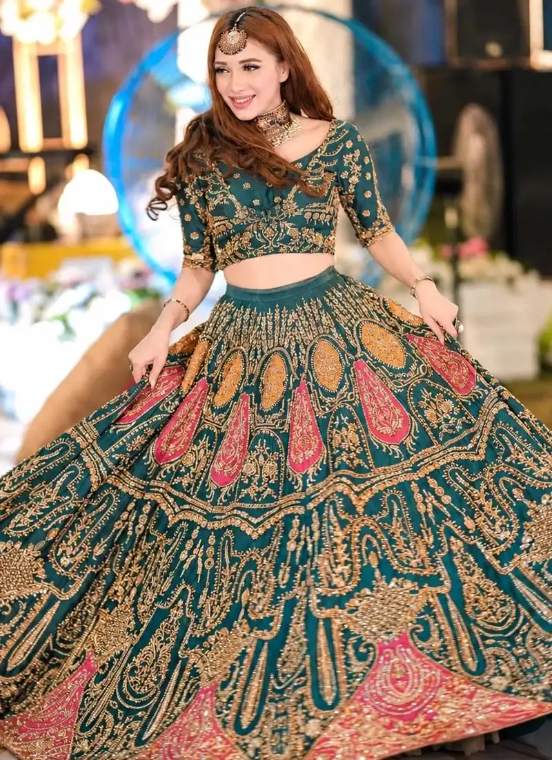 Zinc blue bridal lehenga choli full-length side view with antique-gold embroidery and fuchsia paisley border